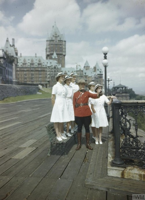 A member of the Canadian Mounted Police Force shows WRNS officers thesights of Quebec, after the fir
