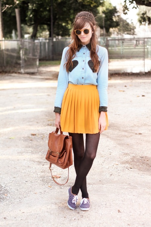 Black sheer pantyhose with pleated yellow skirt and denim shirt with heart shaped patches