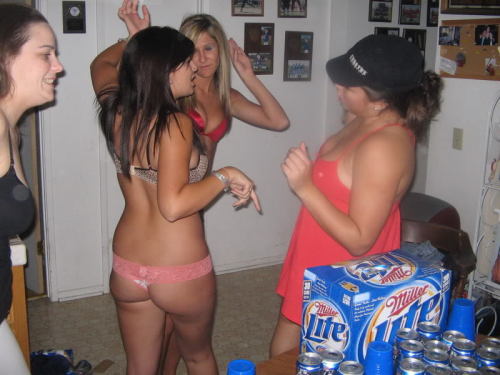 A fun strip flip cup game - the girls are already down to bras and thongs at the start of the photos