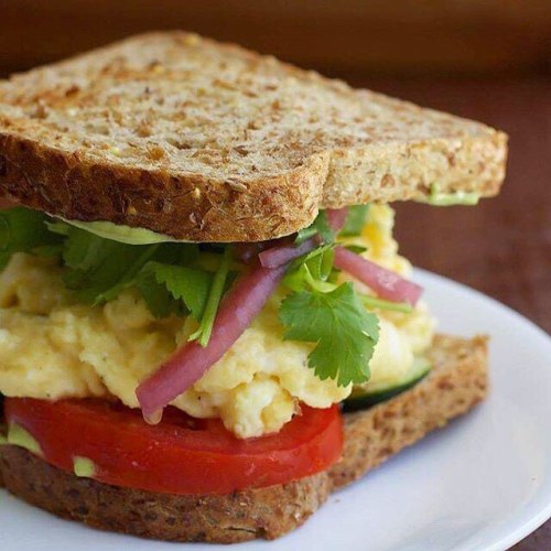 #Breakfast! Scrambled #eggs on #Ezekiel bread with pickled red onions, thinly sliced cucumber, cilan