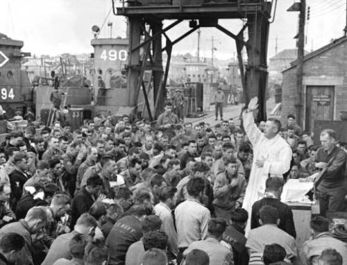 Father (Maj.) Edward J. Waters, a Catholic priest, prays the Mass for sailors and soldiers due to hi