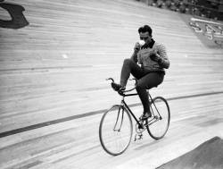 hauntedbystorytelling:    Derek Berwin :: Dutch cyclist Piet Van Kempen circles the track (while reading a newspaper and sipping tea) at Wembley during a six day cycling event, London, 25th September 1936 (Fox Photos/Getty Images)  