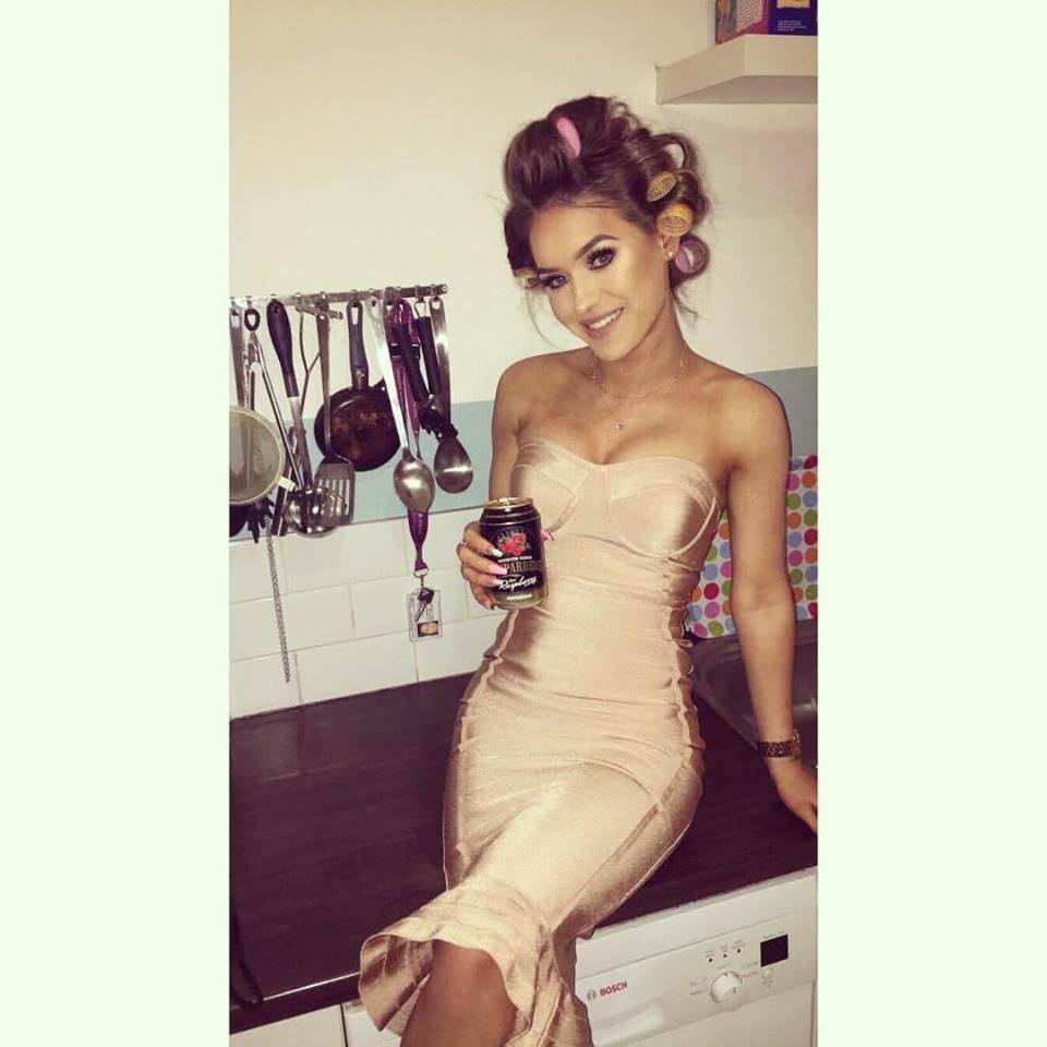 Dress and makeup ready, rollers still in hair, chilling on kitchen counter with beer