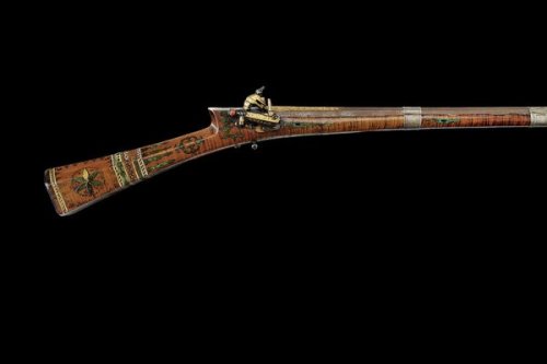 A brass and gold decorated, green painted miquelet musket originating from Turkey, 19th century.