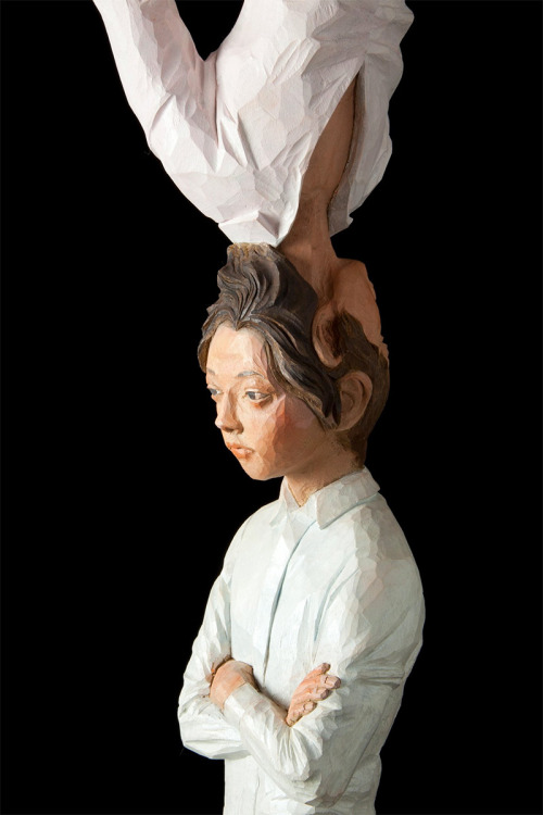 sixpenceee:  The bizarre art of Yoshitoshi Kanemaki. He chisels these life-sized figurative sculptures out of giant pieces of camphor wood, a kind of evergreen. The strange pieces frequently involve two or more characters merged into a single form, which