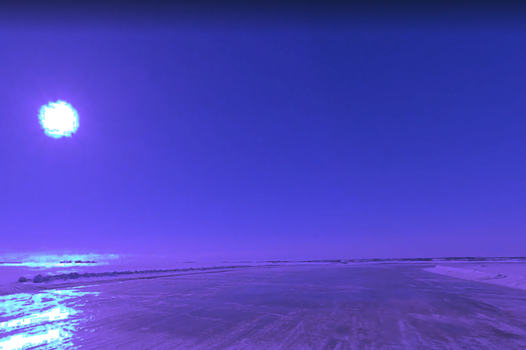 An icy path to the sea, overlooked by the winter sun.