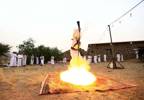 Saudi Arabian man performing a traditional dance with a musket.