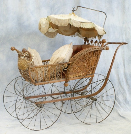 Victorian wicker carriage with parasol top.