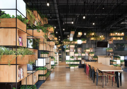 cubebreaker:  This Beijing cafe is a lesson in sustainable design, using recycled materials throughout including upcycled steel bars for its modular bins, which hold numerous plants to improve indoor air quality.