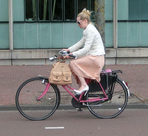 bicycle-amsterdam:  Girl on pink granny bike. Downtown, Amsterdam.