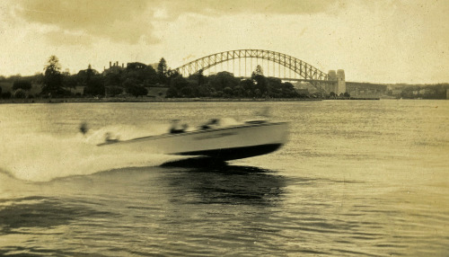 Speedboat at Farm Cove (October 1932).  The new Sydney Harbour Bridge is in the background.