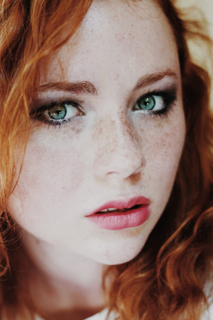 Stunning green-eyed, freckled ginger beauty.