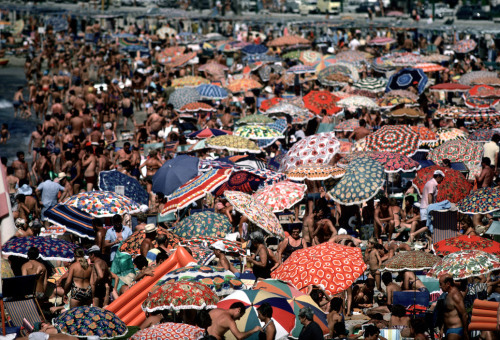 unrar:Spain, Benidorm,1977. A lollipop pattern of parasols crowds the shore. David Alan Harvey.