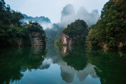 nubbsgalore:photos by michael yamashita in wulingyuan. stretching over more than 26,000 hectares in china’s hunan province, the site is dominated by more than three thousand narrow sandstone pillars and peaks, many over two hundred metres high and