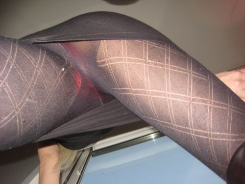 in-pantyhose: Below view of red panties under black patterned pantyhose. Woman in pantyhose