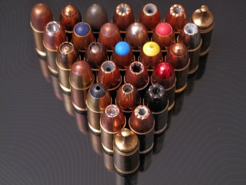freexcitizen:  gunrunnerhell: Taste the rainbow… Sorry, that’s the first thing that popped into my head cause it reminded me of Skittles, well that and billiard balls. An interesting assortment of .45 ACP. My favorite one there? The Black Talon. 