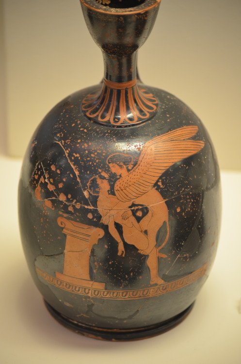 rainbowodyssey:athens-archaeological-museum:A squat lekythos with a Sphinx abducting youth, by Polli
