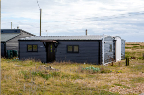 This is so cute- the white part of this home in Dungeness, UK is an old train car, sandwiched in the