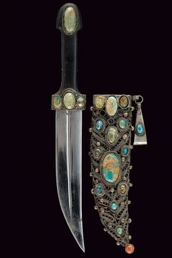 art-of-swords:  Bebut-style (Kindjal) DaggerDated: circa 1900Culture: IndopersianMeasurements: overall length 33cmThe dagger has a curved, double-edged blade, with central fuller. The dark horn grip is decorated with four cabochon turquoises. The silver