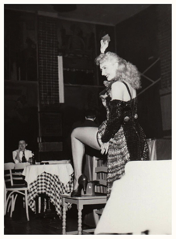 Lynne O’Neill flashes her leg to the audience, during a performance at an unidentified