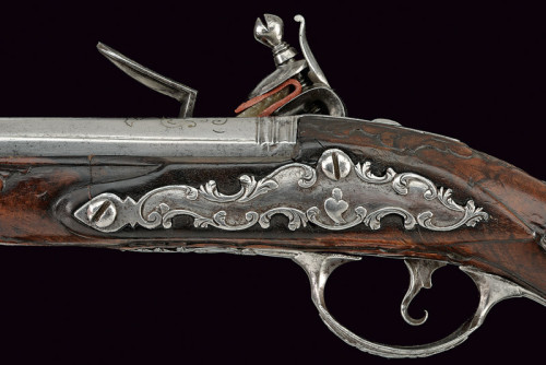 An ornate silver mounted flintlock pistol crafted by G.M. Logia, Brescia, Italy, mid 18th century.