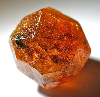 The Soul StoneThis crystal is a spessartine, a manganese-bearing garnet. Spessartine gets its orange