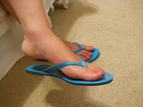 Pretty feet wearing basic blue thong sandals.