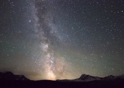 mamakimberleee:  s-c-i-guy:  I took this photo last June on my trip through Glacier National Park, Montana. It was taken on a night with a new moon and it was so dark and the Milky Way was so bright it actually cast a shadow. The stretch of mountains