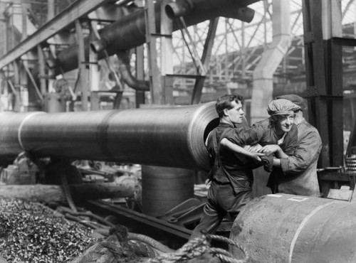 observationballoons:A female worker lies inside the barrel of a naval gun to clean the rifling - Cov