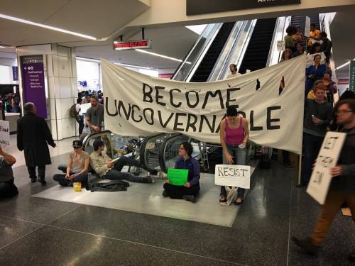 Escalator upstairs Blocked with banner and chairs. #SFO #MuslimBan (at San Francisco International A
