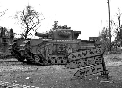 ww1ww2photosfilms:  1944, Germany. A Churchill AVRE (Assault Vehicle Royal Engineers) entering Geile