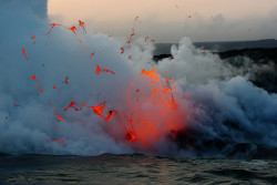 szelence:  Kilauea volcano lava flow spitting into the air and ocean by slworking2 on Flickr. 