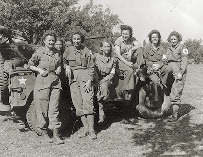 August 12, 1944: a band of battle-hardened nurses take a break to get their picture taken in a field