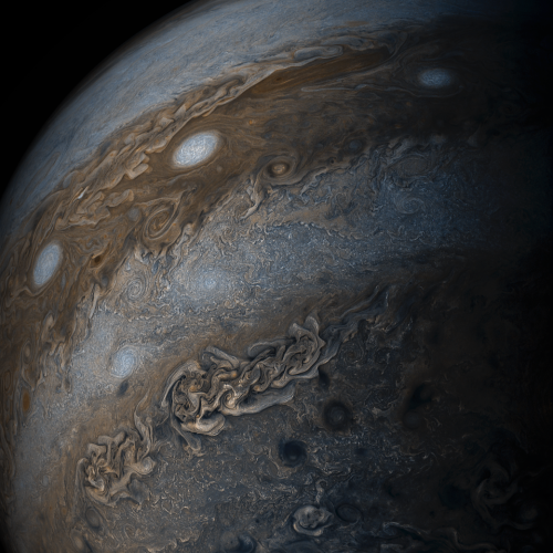 Swirling bands of light and dark clouds on Jupiter are seen in this image made by citizen scientists