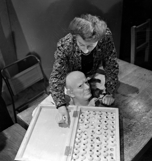 George Konig - Vera Bland chooses the right colour eyeballs for a wax head of Cardinal Bernard Griffin, Archbishop of Westminster in the workshop of Madame Tussaud’s, London, June 1946.