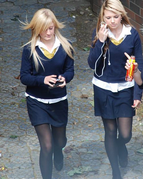 schooluniformfashions: Two girls walk down a path wearing black tights.