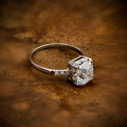 estatediamondjewelry:  Antique Cushion Cut Diamond Engagement Ring, set in platinum mounting, and adorned with smaller diamonds along the shoulder.Old-mine cut diamond circa 1920.Sold by Estate Diamond Jewelry
