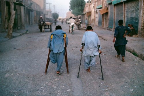 visitafghanistan:Young boys, victims of landmines, walk down the street in Herat, Afghanistan, 1992