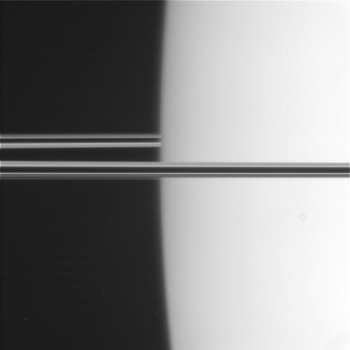 pappubahry:  Mimas emerging from behind Saturn.  Photographed by Cassini, 26 October 2007.