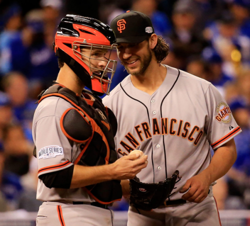 Madison Bumgarner and Buster Posey talk during Game One of the 2014 World Series on October 21, 2014