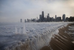 tthejunket:  Lake Michigan  A frozen Lake Michigan sits still in front of the Chicago skyline. Chicago felt a record low temperature of -16 degrees Fahrenheit on Monday.  
