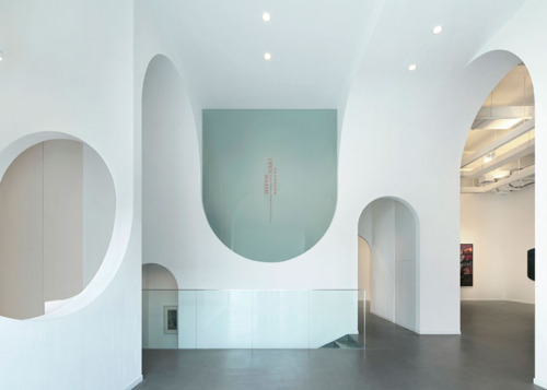 dezeen:  A sequence of arches creates topsy-turvy openings and curvy doorways through the spaces of this art gallery in Beijing 