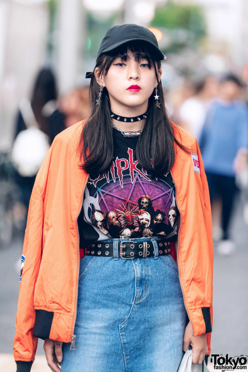 15-year-old Japanese student Kaya on the street in Harajuku wearing a NASA bomber jacket over a Slip