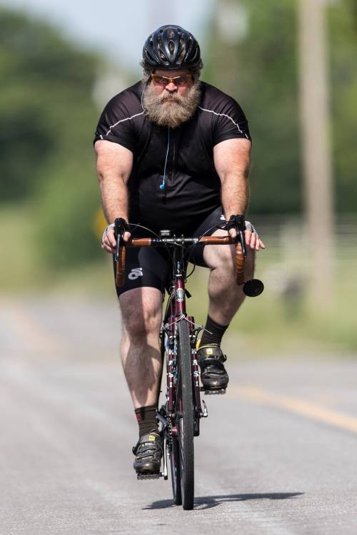 XXX Big, burly, bearded guy on my kind of bike! photo