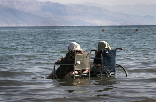 killing-the-prophet:Elderly Palestinian women sit in wheelchairs as they enjoy the waters of the nor