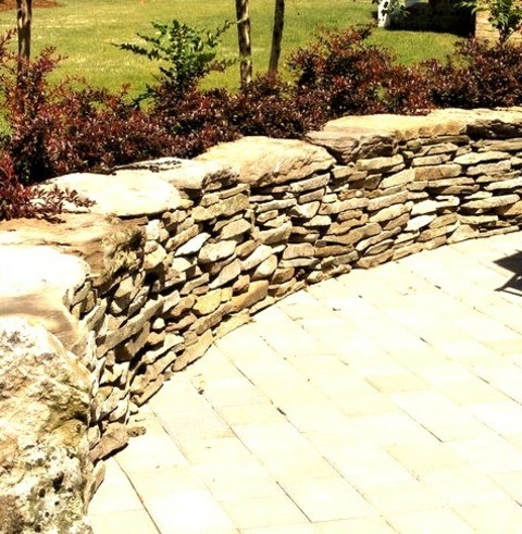 Landscape Retaining WallsAn Example Of A Large Transitional Shade Backyard Concrete Paver Retaining Wall