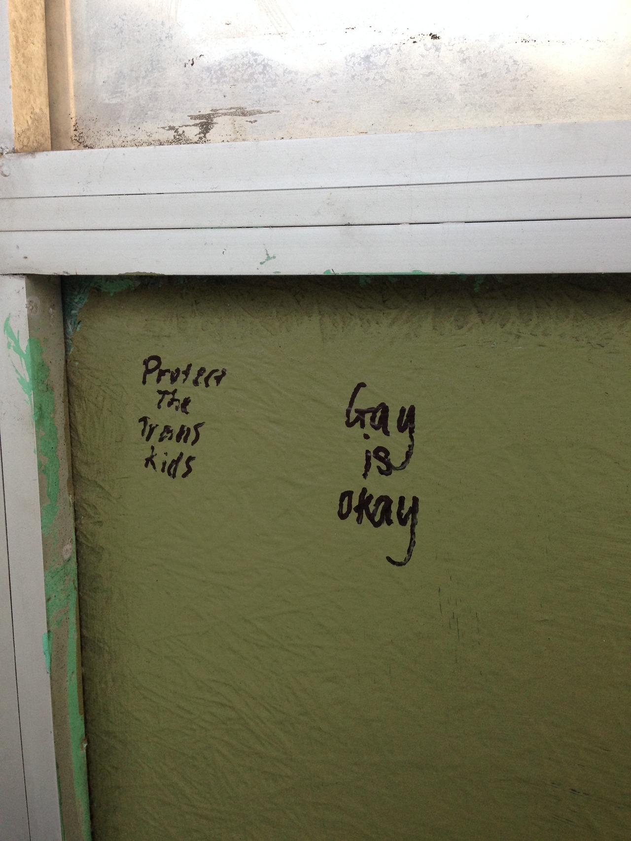 queergraffiti:  “Protect the trans kids” “Gay is okay” Written on a bus stop