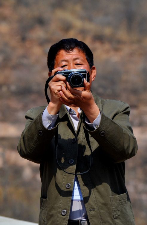 Chinese tourist taking photos of the laiwei (foreigners) at the Nangudong  Reservoir, located i