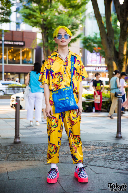 19-year-old Taishin on the street in Harajuku wearing an all over print setup by the Japanese brand 