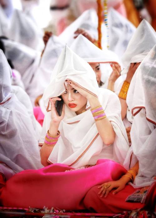 Beautiful veiled woman protecting themselves from the colored powders, Holi Festival at Radha Govind